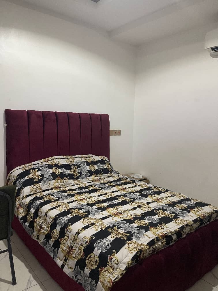 Deluxe Room Queen Bed with Burgundy Headboard at Kelvin Cameo Resort Annex
